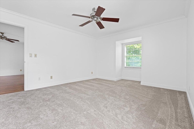 carpeted empty room featuring ceiling fan and ornamental molding