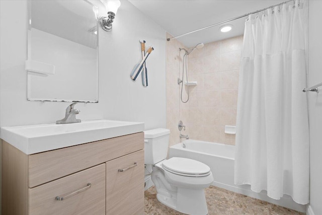 full bathroom with vanity, shower / bath combo, and toilet