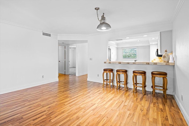 interior space with light hardwood / wood-style floors and crown molding