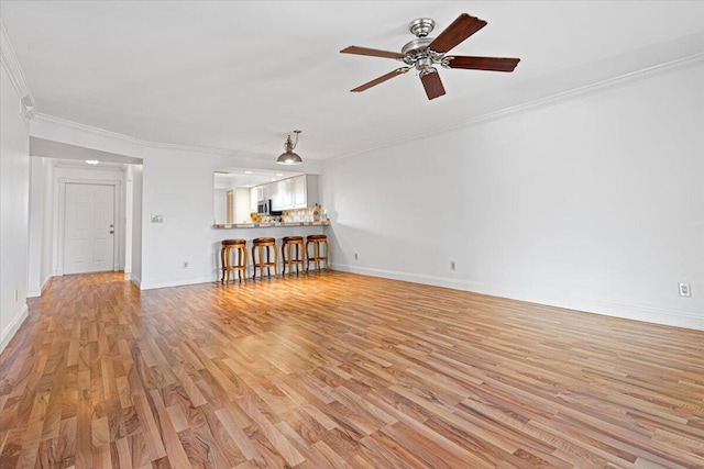 unfurnished living room featuring ceiling fan, light hardwood / wood-style flooring, and ornamental molding