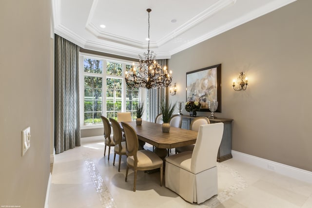 dining area featuring an inviting chandelier, light tile patterned floors, crown molding, and a tray ceiling