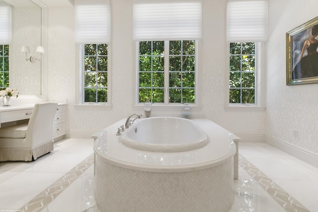 bathroom with tile patterned floors, a washtub, and vanity