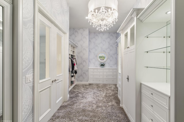 spacious closet featuring carpet and a chandelier