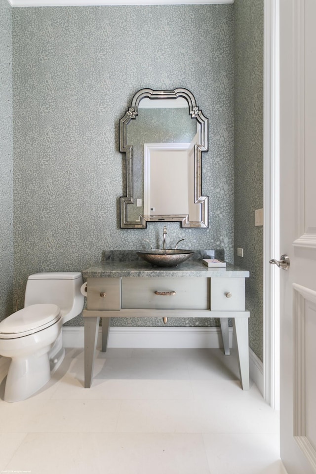 bathroom with tile patterned floors, vanity, and toilet