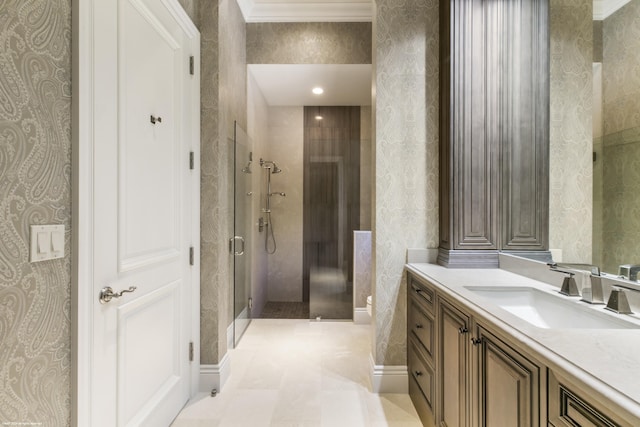 bathroom featuring a shower with door and vanity