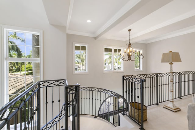 corridor featuring beam ceiling, crown molding, and a chandelier