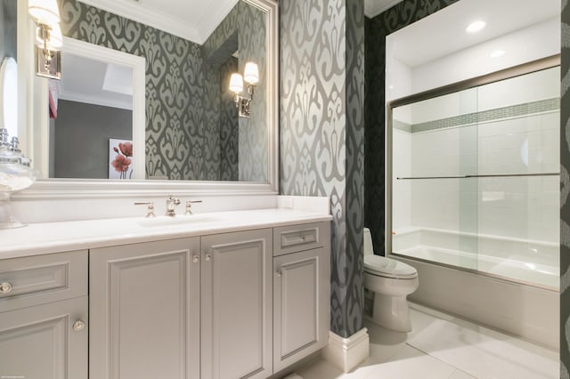 full bathroom with vanity, bath / shower combo with glass door, crown molding, tile patterned flooring, and toilet