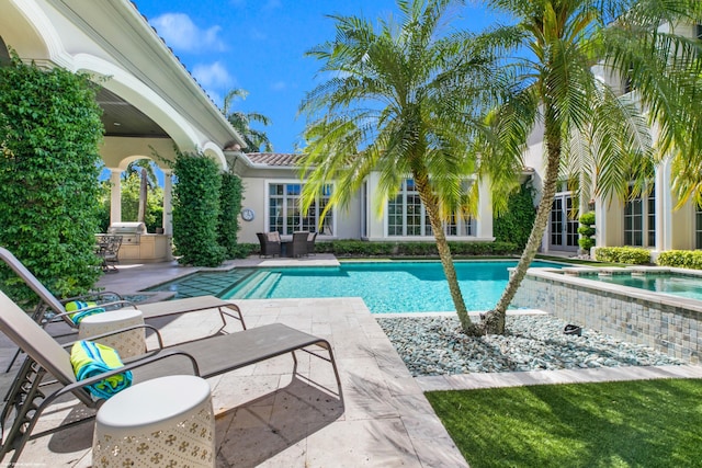 view of swimming pool with area for grilling, an in ground hot tub, and a patio