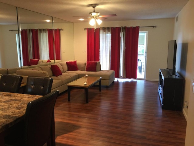 living room featuring dark hardwood / wood-style floors and ceiling fan