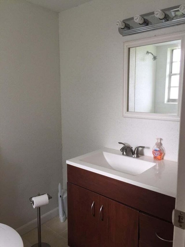 bathroom with tile patterned floors, vanity, and toilet