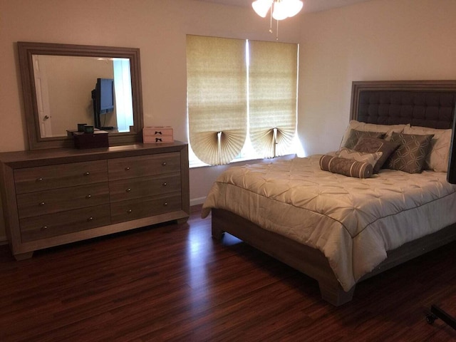 bedroom with dark wood-type flooring