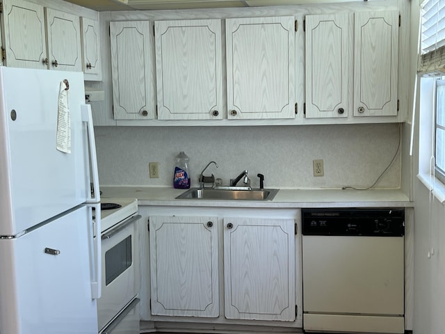 kitchen with decorative backsplash, white appliances, and sink