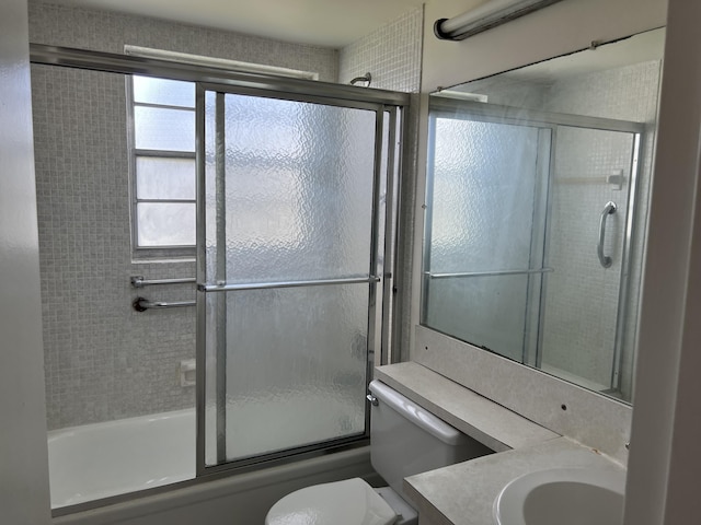 full bathroom with shower / bath combination with glass door, vanity, and toilet