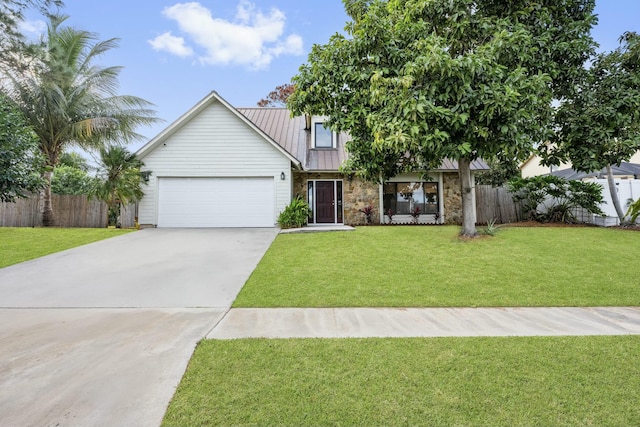 view of front of property with a front yard and a garage