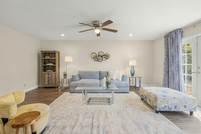 living room with ceiling fan and wood-type flooring