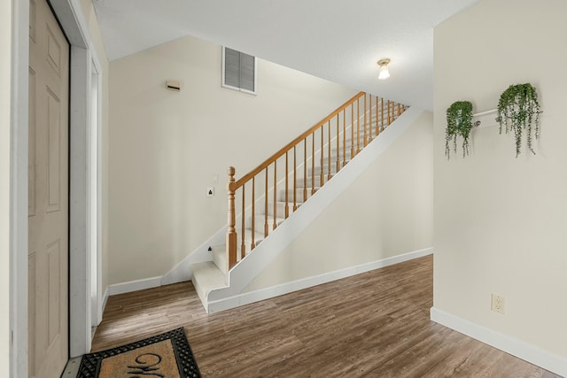 stairs featuring wood-type flooring