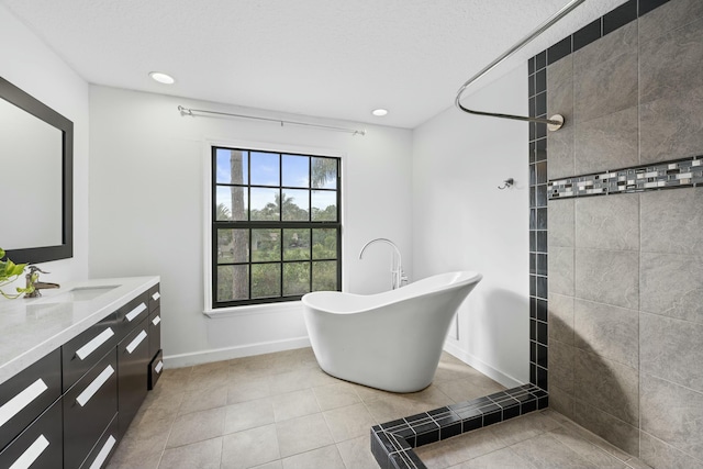 bathroom with tile patterned floors, vanity, and separate shower and tub