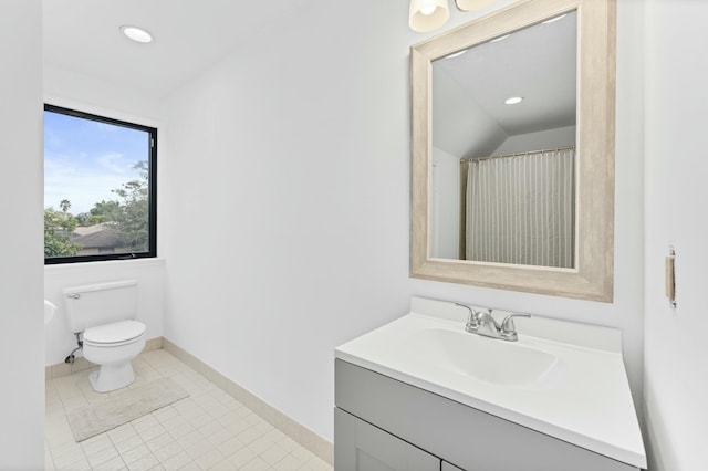 bathroom featuring tile patterned flooring, vanity, toilet, and curtained shower