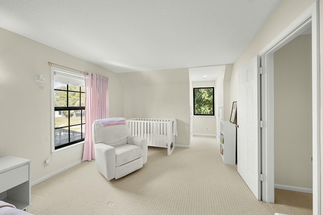 carpeted bedroom with a crib