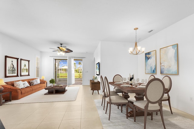 dining space featuring light tile patterned floors and ceiling fan with notable chandelier