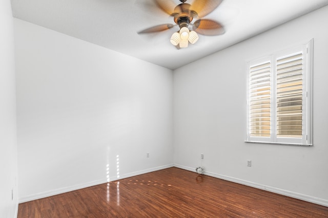 unfurnished room with ceiling fan, dark wood-type flooring, and a wealth of natural light