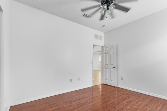 spare room with hardwood / wood-style flooring and ceiling fan