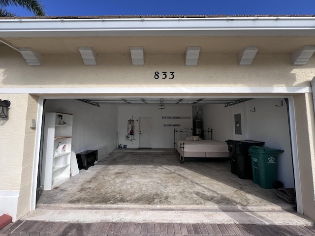 garage with electric panel and water heater