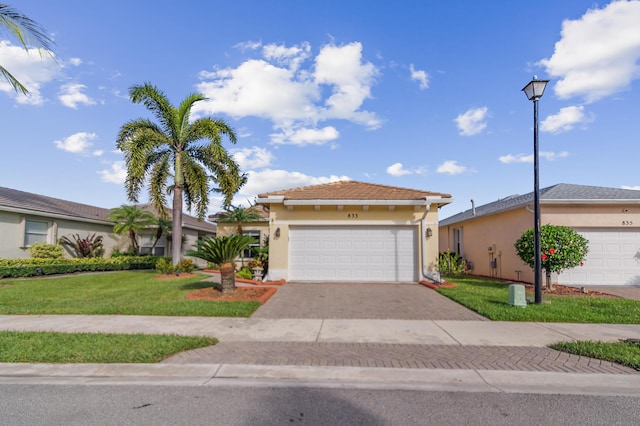 view of front of home with a front lawn and a garage