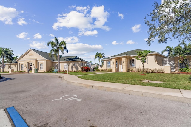 single story home with a front lawn