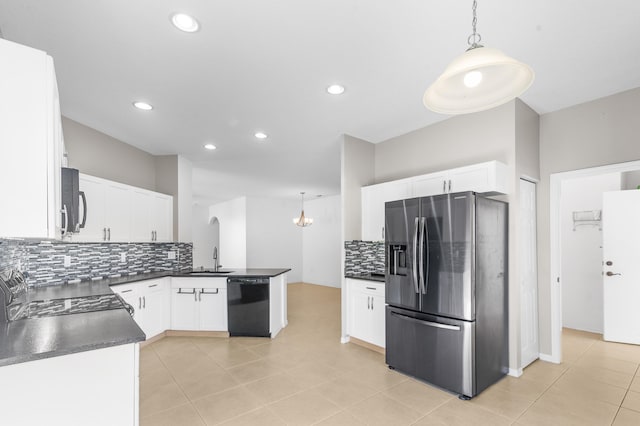 kitchen with kitchen peninsula, tasteful backsplash, stainless steel appliances, white cabinets, and hanging light fixtures