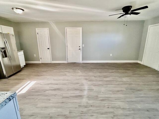 interior space with ceiling fan and light wood-type flooring