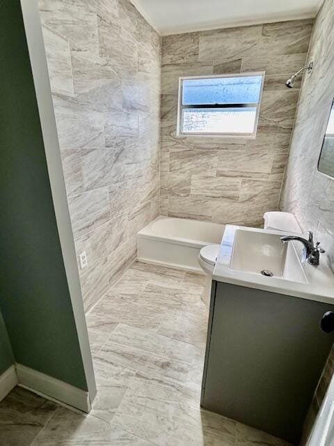 full bathroom with shower / bathing tub combination, vanity, toilet, and tile walls