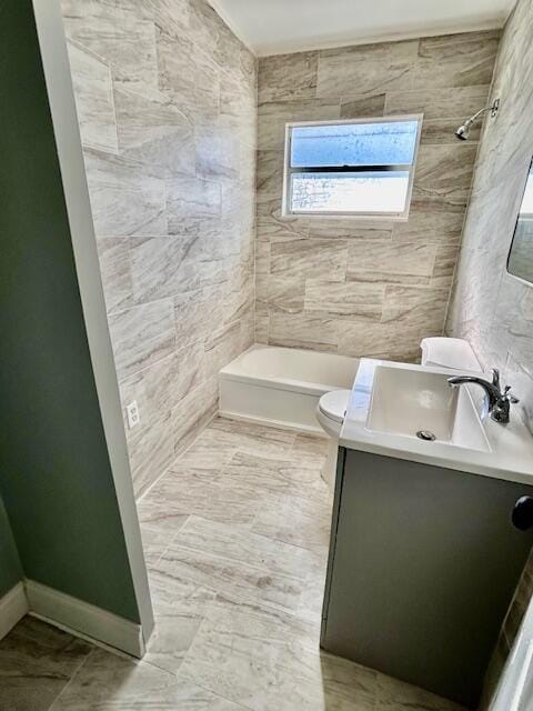 bathroom with vanity, bathtub / shower combination, toilet, and a wealth of natural light