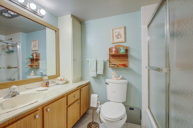 full bathroom featuring vanity, tile patterned flooring, toilet, and bath / shower combo with glass door