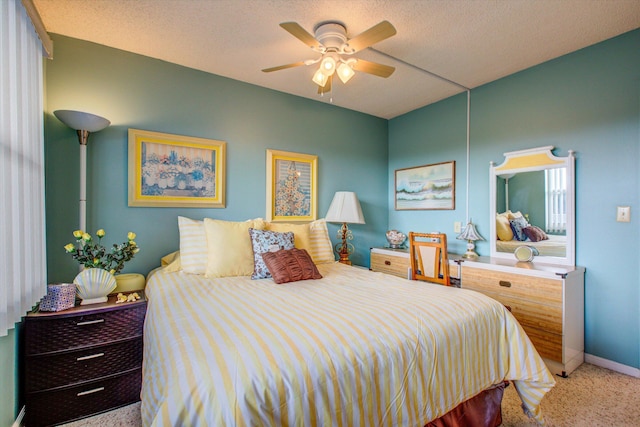 carpeted bedroom with ceiling fan and a textured ceiling