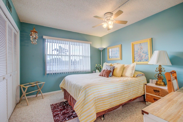 bedroom with ceiling fan, a closet, and a textured ceiling