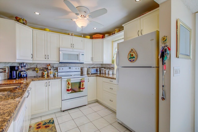 kitchen with white appliances, light tile patterned floors, stone countertops, backsplash, and white cabinets