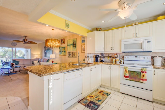 kitchen with white appliances, white cabinetry, and kitchen peninsula