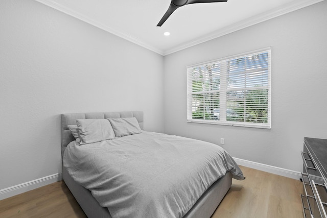 bedroom featuring ceiling fan, crown molding, and light wood-type flooring