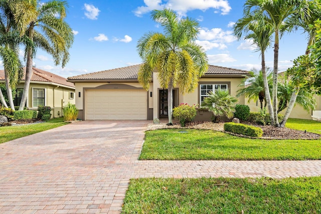 mediterranean / spanish-style home featuring a garage and a front lawn