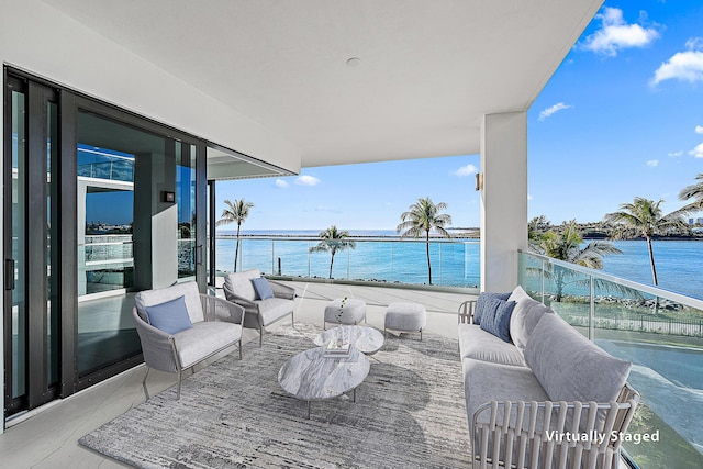 balcony with an outdoor living space and a water view