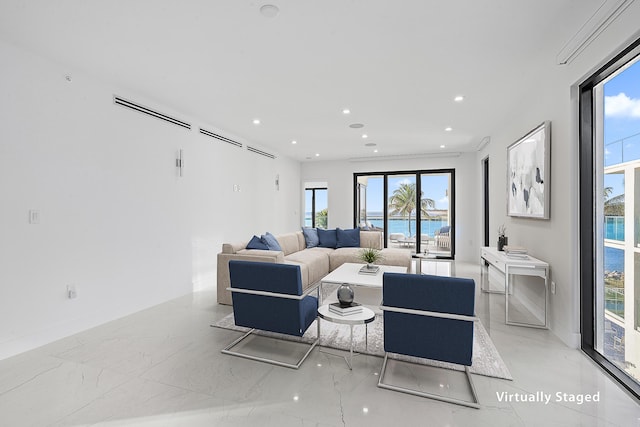 living area with recessed lighting, baseboards, and marble finish floor