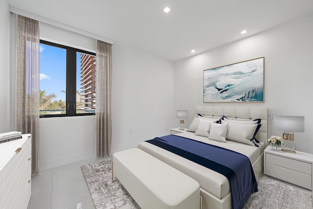 bedroom with recessed lighting, marble finish floor, and baseboards