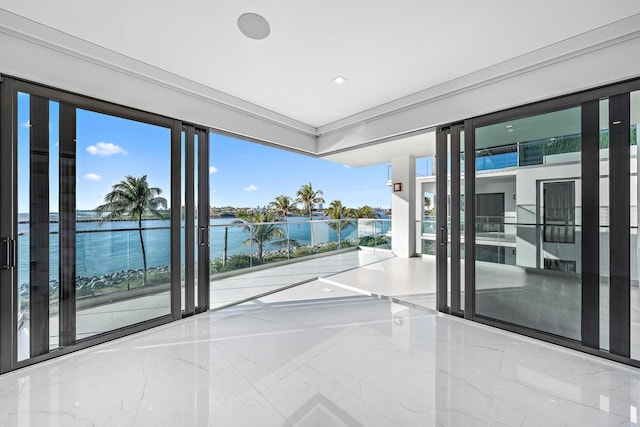 interior space featuring a water view and marble finish floor