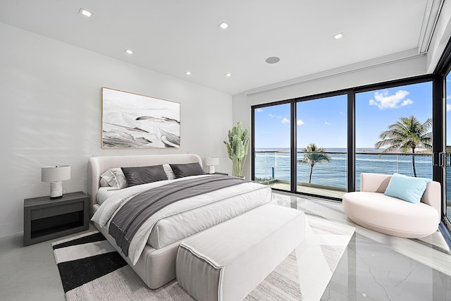 bedroom featuring a water view and access to exterior