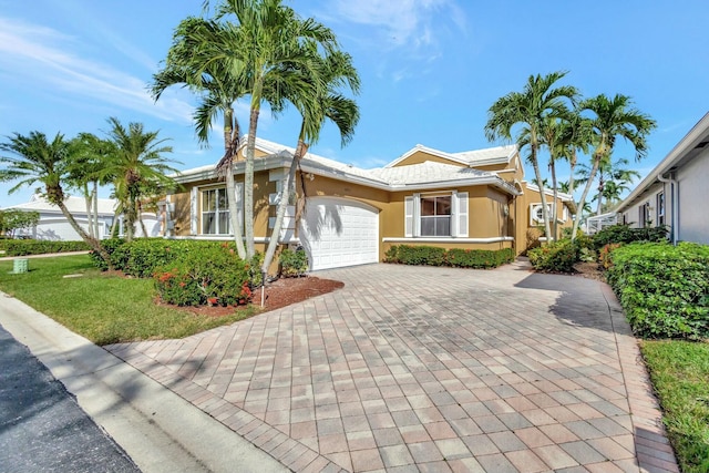 single story home featuring a front yard and a garage