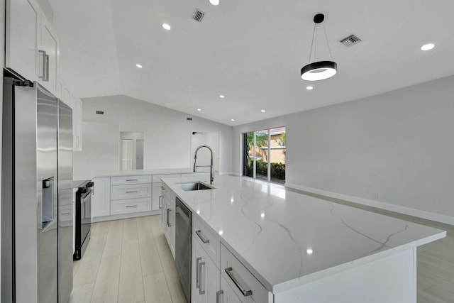 kitchen with a spacious island, white cabinetry, sink, and stainless steel appliances