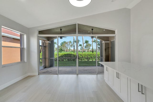 unfurnished room featuring light hardwood / wood-style flooring and vaulted ceiling