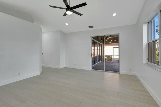 unfurnished room featuring ceiling fan, light hardwood / wood-style floors, and lofted ceiling