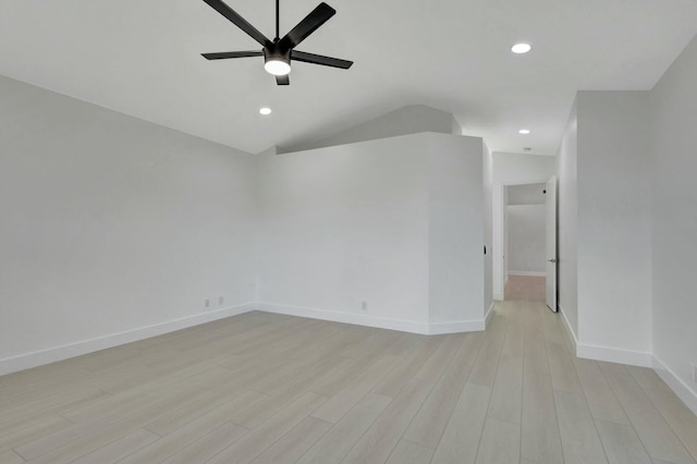 spare room with ceiling fan, light hardwood / wood-style flooring, and vaulted ceiling